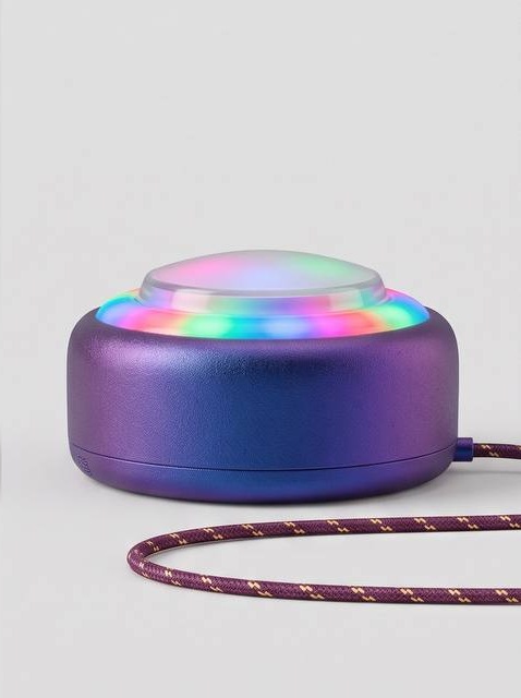 Side view of the Puck device with its ring of lights lit.
